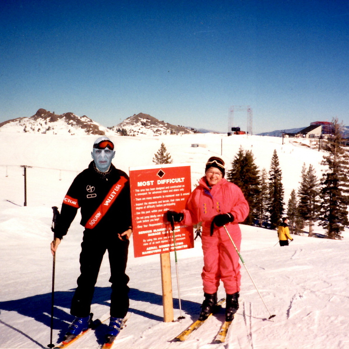 ski instructor and Dr. Ruth Westheimer at Squaw Valley USA with "black diamond" ski sign
